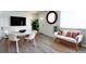 Well-lit living area with dining table, sofa and flat-screen tv at 8627 Santa Fe Dr, Thornton, CO 80260