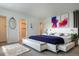 Serene main bedroom with plush carpeting, ensuite access, and contemporary decor at 8627 Santa Fe Dr, Thornton, CO 80260