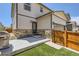 Backyard area featuring a patio, artificial grass, a wooden fence, and stylish exterior accents at 764 N Quatar St, Aurora, CO 80018