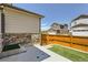 Backyard area with a concrete patio, small patch of grass, and a wooden fence at 764 N Quatar St, Aurora, CO 80018