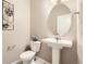 Powder room has a pedestal sink, oval mirror, and decorative metal wall art at 764 N Quatar St, Aurora, CO 80018