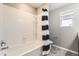 Clean bathroom features a shower/tub combination with a decorative shower curtain at 764 N Quatar St, Aurora, CO 80018