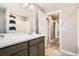 Bathroom with double vanity, shower/tub combo and view to hall at 764 N Quatar St, Aurora, CO 80018