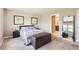 Comfortable bedroom features a full bed with leather storage chest, and a view to the bathroom at 764 N Quatar St, Aurora, CO 80018