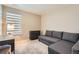 This bedroom includes a gray pull-out couch, a dark desk and drawers, and a bright window at 764 N Quatar St, Aurora, CO 80018