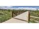 Bridge overlooking a scenic park area with mature trees and walking paths at 764 N Quatar St, Aurora, CO 80018
