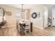 Bright dining area featuring hardwood floors and modern light fixture at 764 N Quatar St, Aurora, CO 80018