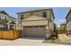 Exterior of house featuring stone accents, a two-car garage, and manicured landscaping at 764 N Quatar St, Aurora, CO 80018