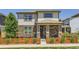 Charming two-story home featuring a stone facade, covered porch, and a fenced front yard at 764 N Quatar St, Aurora, CO 80018