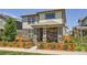 Charming two-story home featuring a stone facade, covered porch, and a fenced front yard at 764 N Quatar St, Aurora, CO 80018