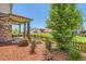 Inviting front porch with stone columns and beautifully landscaped front yard with lush plantings at 764 N Quatar St, Aurora, CO 80018