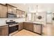 Modern kitchen features stainless appliances, granite countertops and light, bright, open floor plan at 764 N Quatar St, Aurora, CO 80018