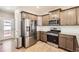Well-equipped kitchen with stainless steel appliances and granite countertops at 764 N Quatar St, Aurora, CO 80018