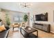 Bright living room with hardwood floors, stylish furnishings, and lots of natural light at 764 N Quatar St, Aurora, CO 80018