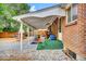 Backyard with a covered patio with outdoor seating and storage space at 61 S 17Th Avdr, Brighton, CO 80601