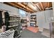Unfinished basement storage space with exposed beams and basic shelves at 61 S 17Th Avdr, Brighton, CO 80601