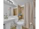 Bathroom featuring ceramic tile, a soaking tub with a shower, and neutral tones at 61 S 17Th Avdr, Brighton, CO 80601