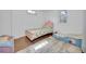 bedroom with hardwood floors features twin beds with colorful bedding and decor at 61 S 17Th Avdr, Brighton, CO 80601