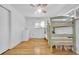 Bright bedroom featuring hardwood floors, bunkbeds, and a pink ceiling fan at 61 S 17Th Avdr, Brighton, CO 80601