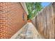 Exterior shot of the side of the house with walkway and stone border at 61 S 17Th Avdr, Brighton, CO 80601