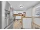 Bright kitchen boasting stainless steel appliances, an island, white cabinetry and checkered floors at 61 S 17Th Avdr, Brighton, CO 80601