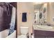 Cozy bathroom with granite countertop, decorative wall art, and shower with patterned curtain at 2001 Lincoln St # 2213, Denver, CO 80202