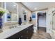 Contemporary bathroom featuring a double vanity, illuminated mirrors, and a walk-in closet at 2001 Lincoln St # 2213, Denver, CO 80202