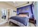 Bedroom featuring a stylish blue accent wall with decor and a glimpse of the en-suite bathroom at 2001 Lincoln St # 2213, Denver, CO 80202