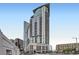 Modern high-rise building with sleek architectural design featuring balconies and city views from a street-level perspective at 2001 Lincoln St # 2213, Denver, CO 80202