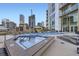 Rooftop pool and hot tub area with cityscape views and lounge seating at 2001 Lincoln St # 2213, Denver, CO 80202