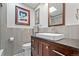 Modern bathroom features a square sink, gray tile and warm wood cabinetry at 7552 Nikau Dr, Niwot, CO 80503
