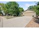 Long concrete driveway leading to a two-car garage, with beautiful landscaping and mature trees surrounding at 7552 Nikau Dr, Niwot, CO 80503