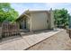 Back of the house with wood siding and a stone pathway, leading to the back door at 7552 Nikau Dr, Niwot, CO 80503