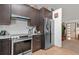 Modern kitchen features stainless steel appliances, granite countertops, and dark wood cabinetry at 7552 Nikau Dr, Niwot, CO 80503