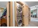 Conveniently located washer and dryer area with stylish wooden doors and a modern design at 7552 Nikau Dr, Niwot, CO 80503