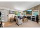 Open-concept living space with a fireplace, large windows, and access to a modern, updated kitchen at 7552 Nikau Dr, Niwot, CO 80503