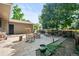 Inviting patio with stone fire pit, mature trees, rocking chair, and tasteful landscaping at 7552 Nikau Dr, Niwot, CO 80503