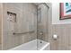Modern bathroom features a shower with gray textured tile, a shower bar, and a stone niche at 7552 Nikau Dr, Niwot, CO 80503