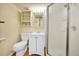 This compact bathroom features a wooden floor, a walk-in shower, and classic fixtures at 3294 Sentinel Dr, Boulder, CO 80301
