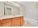 Bathroom featuring a wood vanity with a large mirror, a tile floor, and a tub with shower at 3294 Sentinel Dr, Boulder, CO 80301