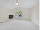 Spacious bedroom with plush carpeting, a tiled fireplace, and a large window at 3294 Sentinel Dr, Boulder, CO 80301