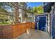 View of side yard with wood fence surrounding a grey and blue home at 3294 Sentinel Dr, Boulder, CO 80301