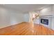 Living room with hardwood floors, fireplace, and open access to the kitchen at 3294 Sentinel Dr, Boulder, CO 80301