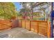 Back patio surrounded by a wood fence and brick border providing privacy at 3294 Sentinel Dr, Boulder, CO 80301