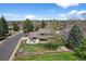 Charming home featuring a spacious backyard with mature trees and outdoor entertaining area on a sunny day at 6918 E Long Ave, Centennial, CO 80112