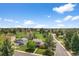 Inviting home with lush landscaping, mature trees, and a sprawling green lawn in a peaceful neighborhood setting at 6918 E Long Ave, Centennial, CO 80112