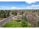 Scenic aerial view showcases a home with outdoor patio and manicured lawn in a lush, tree-filled neighborhood at 6918 E Long Ave, Centennial, CO 80112