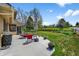 Backyard patio with outdoor seating, a grill, and views of the landscaped lawn and garden at 6918 E Long Ave, Centennial, CO 80112