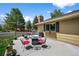 Backyard patio with outdoor seating, a fire pit, and well-manicured lawn at 6918 E Long Ave, Centennial, CO 80112