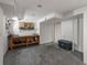 Unfinished basement with a workbench, concrete flooring and access to storage at 6918 E Long Ave, Centennial, CO 80112